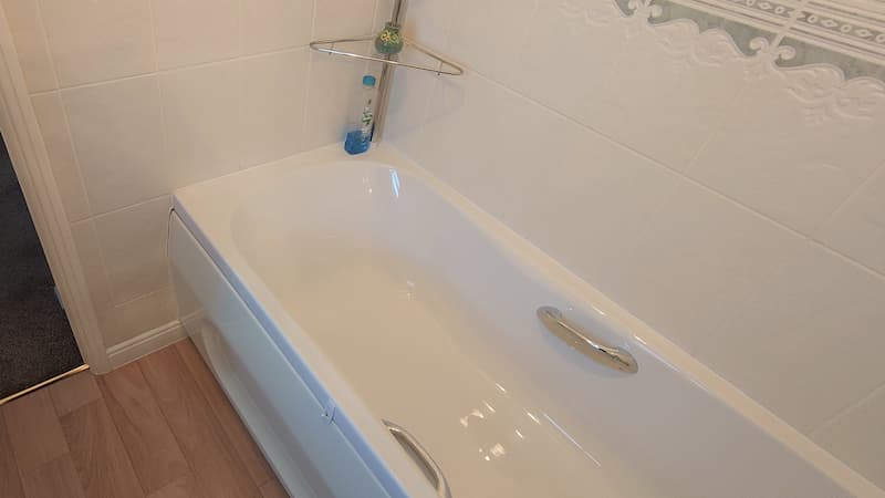 modern white bath with golden side handles