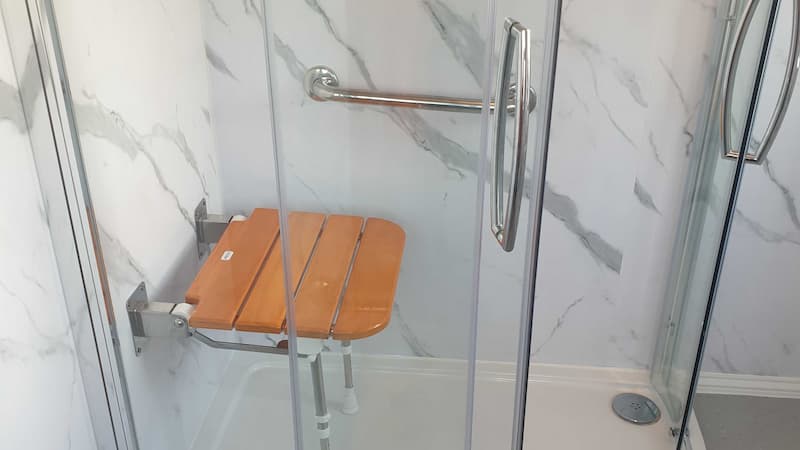 luxury modern shower with wooden panelled folding shower seat