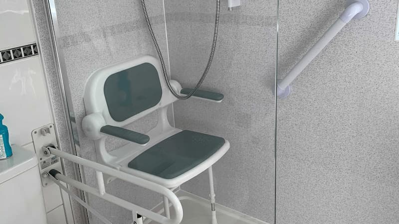 movable white shower seat in shower