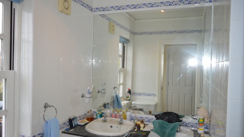 bathroom mirror on white tiled wall