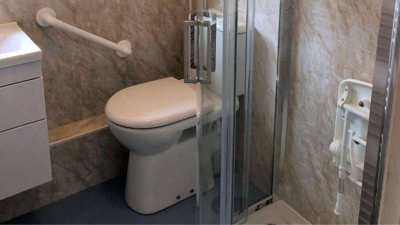 modern style bathroom with white foldable shower seat
